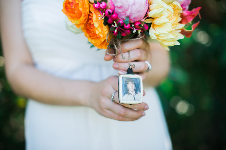 The brides bouquet has a photo of her father attached.