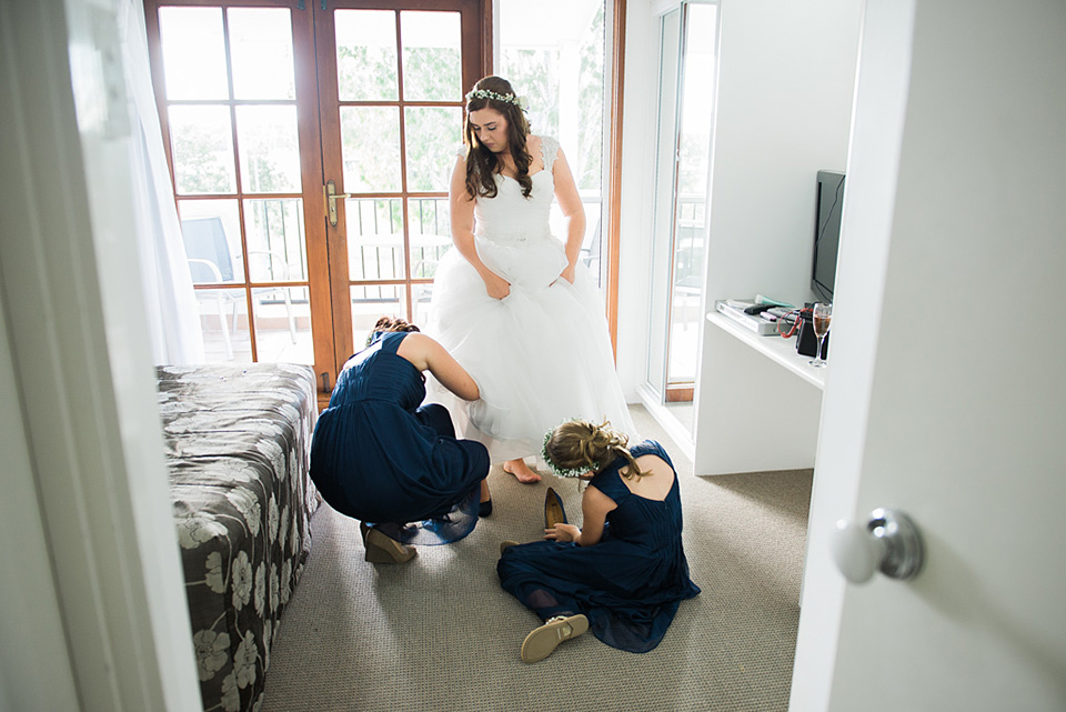 Bride putting her shoes on