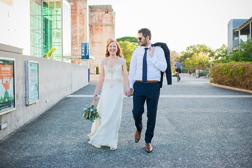 Karen and Brendan walking around the grounds of the Powerhouse Museum in Brisbane. Wedding photos by Lionheart Photography.