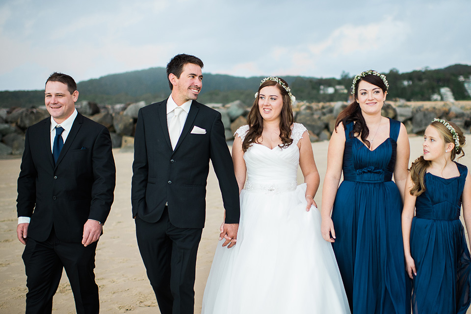 photo of the bridal party on Noosa main beach by wedding photographers, Lionheart Photography.
