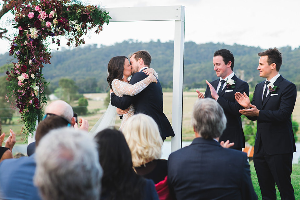 First kiss at the farm wedding ceremony