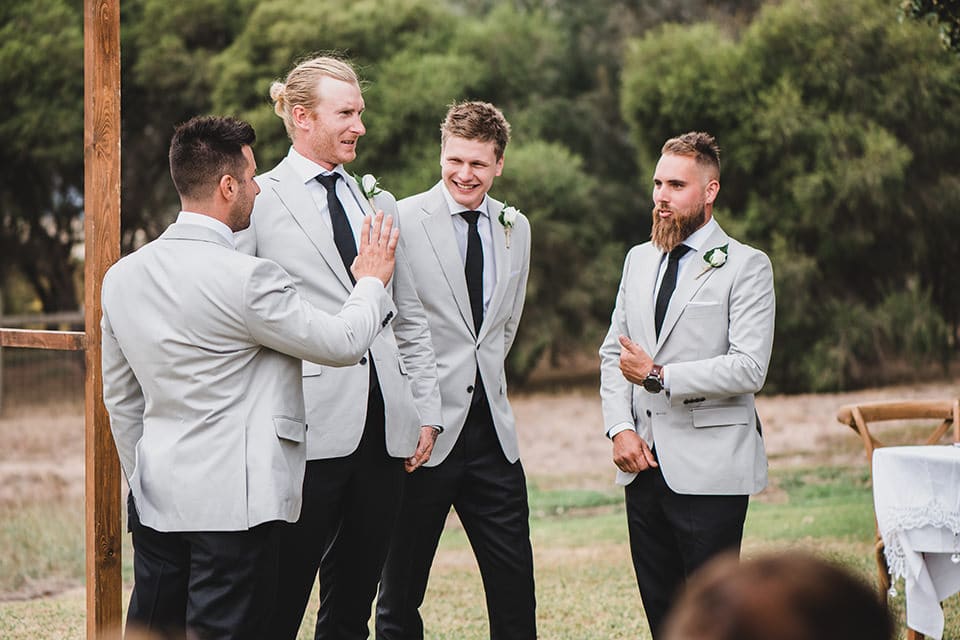 The groomsmen and groom waiting for the bride to walk down the isle at Terindah Estate.